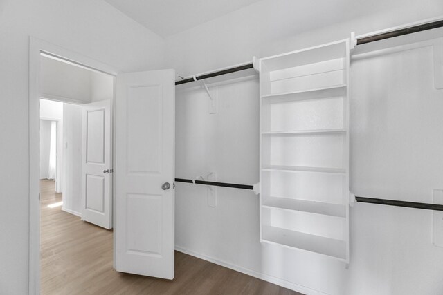 walk in closet featuring wood finished floors