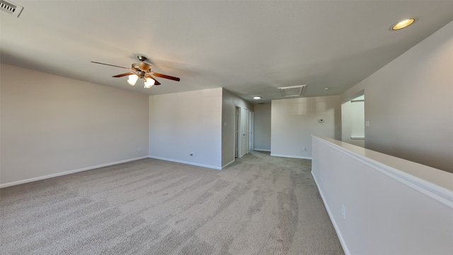 spare room featuring recessed lighting, light carpet, a ceiling fan, visible vents, and baseboards