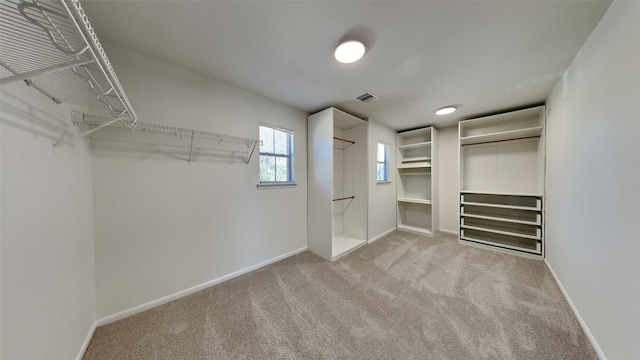 walk in closet featuring carpet floors and visible vents