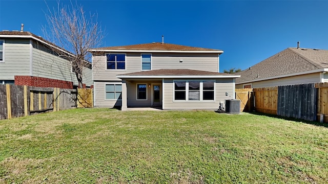 back of house featuring a fenced backyard, a lawn, and central air condition unit