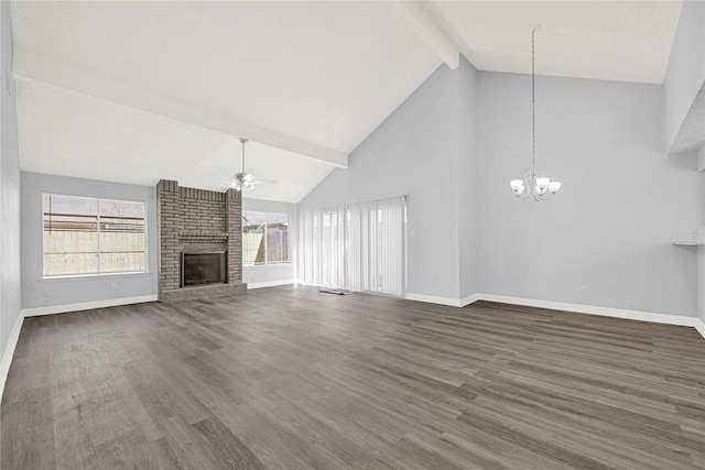 unfurnished living room featuring wood finished floors, baseboards, a fireplace, beamed ceiling, and ceiling fan with notable chandelier