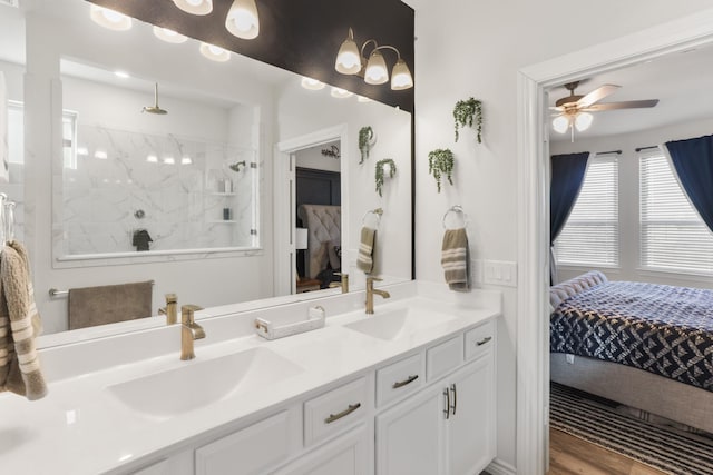 ensuite bathroom featuring double vanity, walk in shower, a sink, and ensuite bathroom