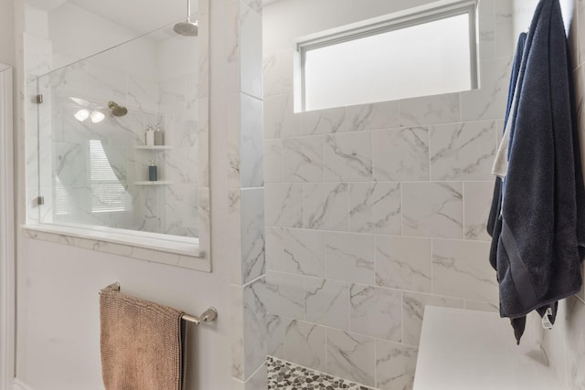 bathroom with a marble finish shower