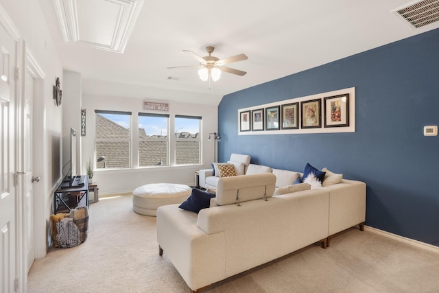 carpeted living room with baseboards, visible vents, and attic access