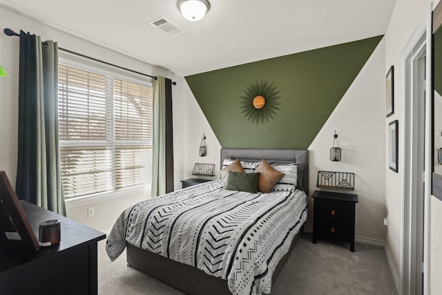 carpeted bedroom featuring visible vents, baseboards, and multiple windows