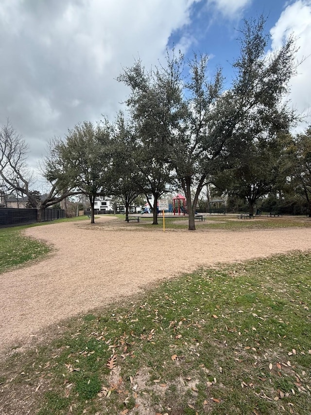 view of property's community featuring playground community and fence