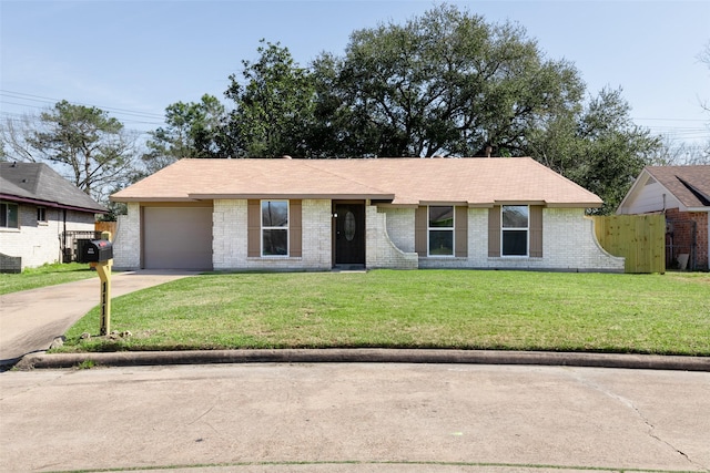 ranch-style home featuring a garage, a front lawn, concrete driveway, and brick siding