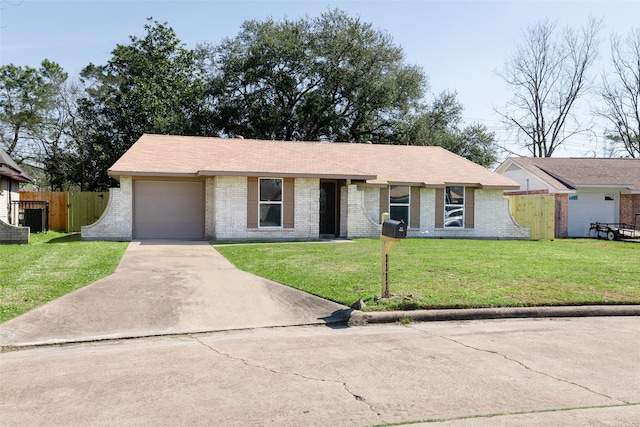 single story home with driveway, an attached garage, fence, a front yard, and brick siding