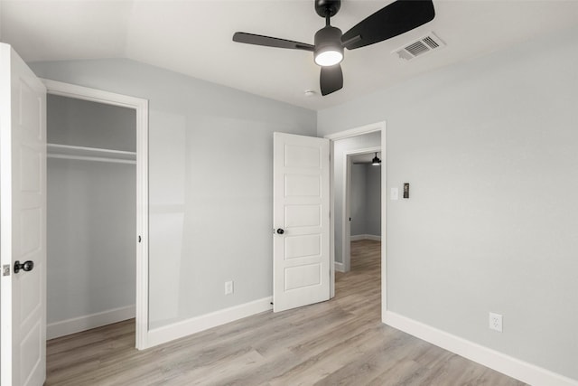 unfurnished bedroom with light wood finished floors, baseboards, visible vents, and a closet