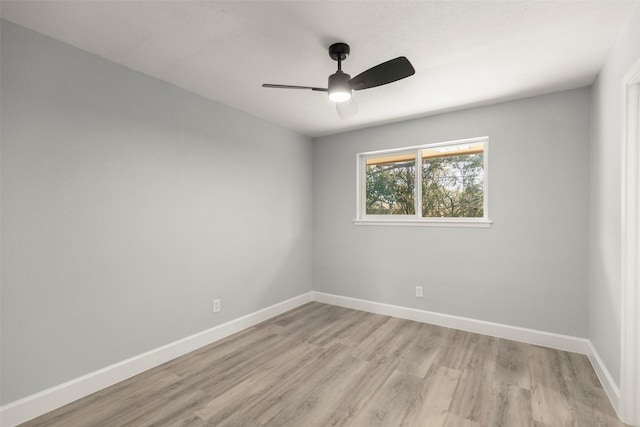 empty room with light wood-style flooring, baseboards, and ceiling fan