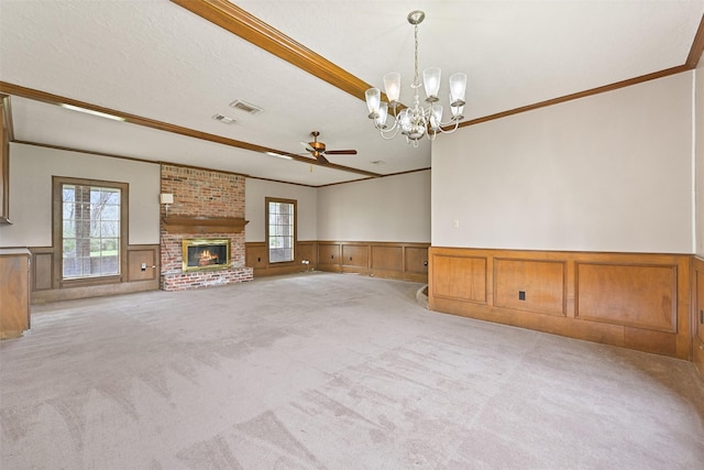 unfurnished living room with a wealth of natural light, visible vents, and light colored carpet