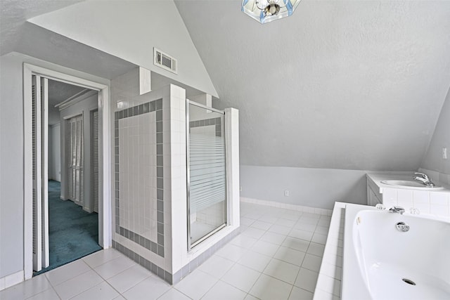 full bathroom featuring lofted ceiling, visible vents, a stall shower, a sink, and tile patterned floors