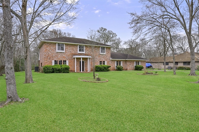 view of front facade featuring a front lawn and brick siding