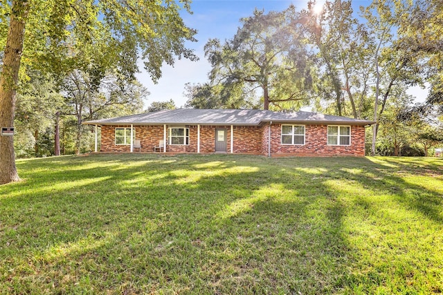 ranch-style home featuring a front yard and brick siding