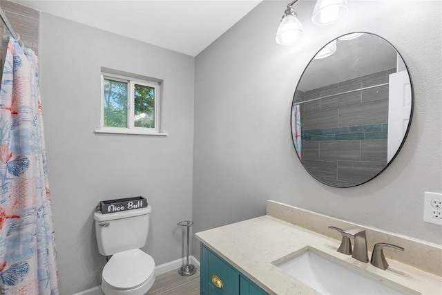 bathroom featuring toilet, a shower with curtain, baseboards, and vanity