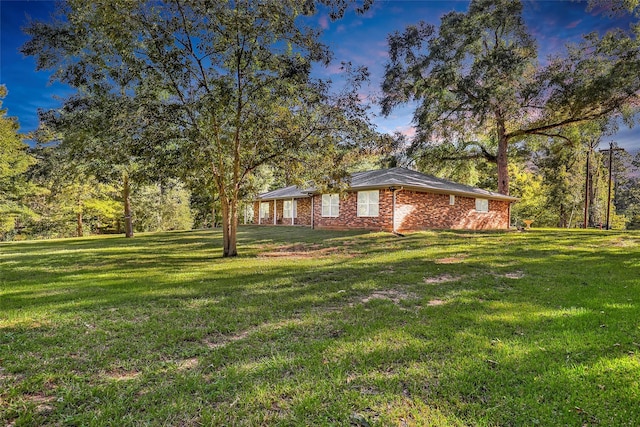 exterior space with a lawn and brick siding