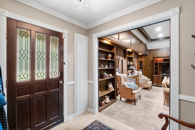 entrance foyer with light carpet, crown molding, and light tile patterned flooring