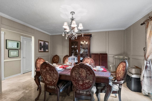 dining space with a chandelier, a decorative wall, and ornamental molding