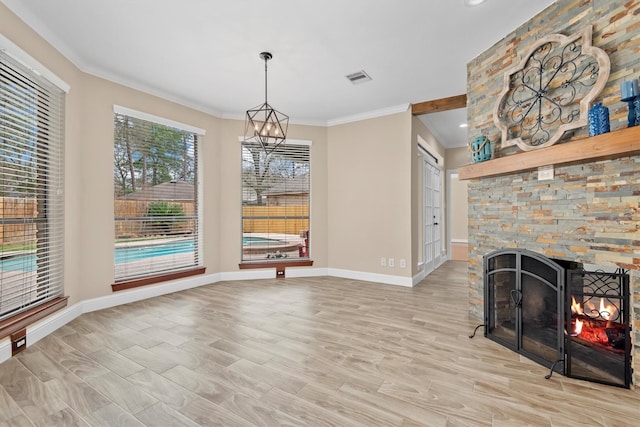 interior space with a fireplace, visible vents, baseboards, ornamental molding, and light wood-type flooring