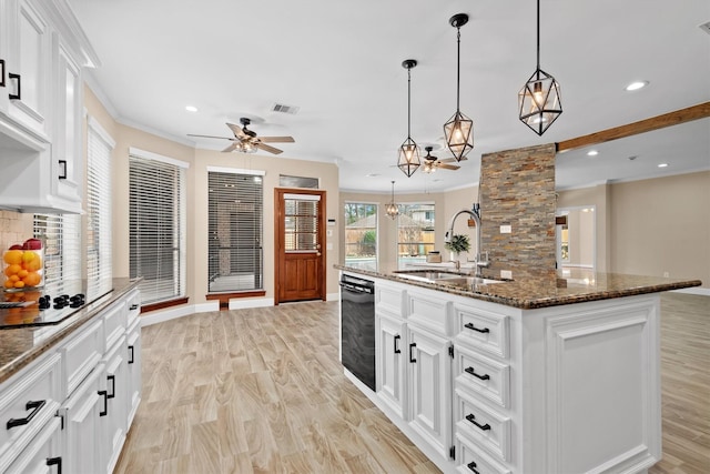 kitchen with visible vents, black electric stovetop, light wood-style flooring, and a sink