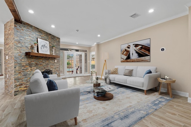 living area with visible vents, baseboards, ornamental molding, french doors, and light wood finished floors