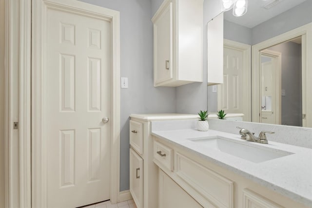 bathroom with vanity, visible vents, and tile patterned floors