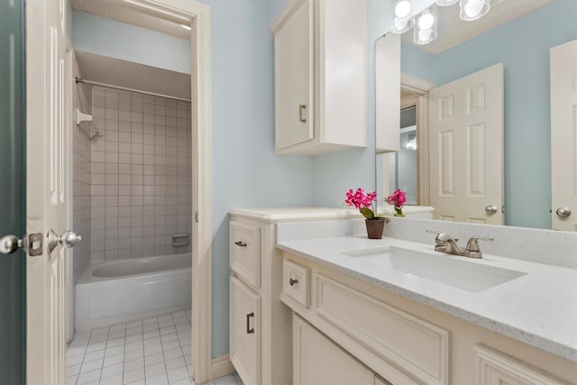 full bathroom with washtub / shower combination, vanity, and tile patterned floors