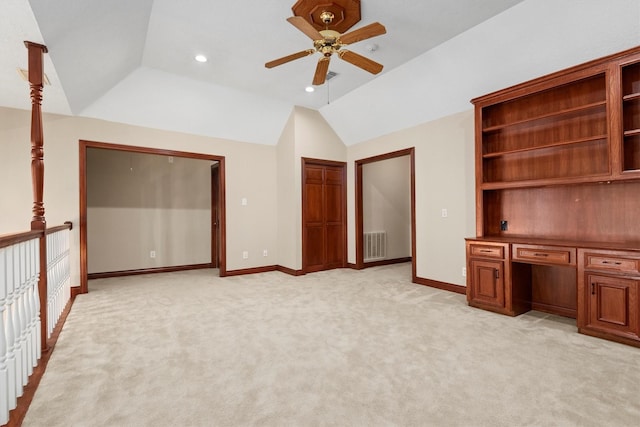 unfurnished bedroom with lofted ceiling, baseboards, light carpet, and visible vents