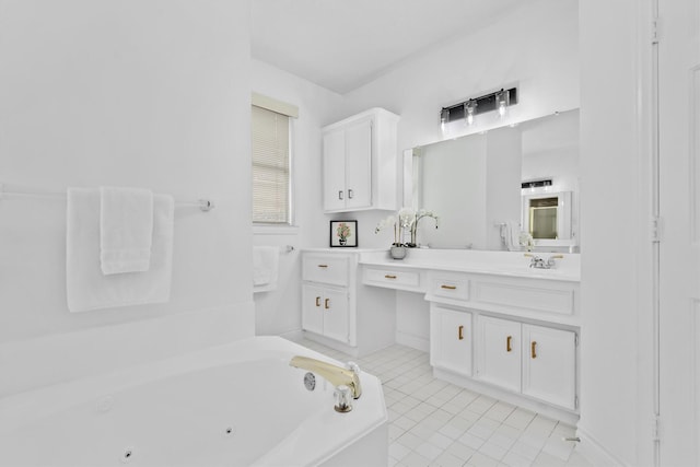 full bathroom with vanity, a tub with jets, and tile patterned floors