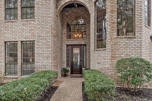 doorway to property with brick siding