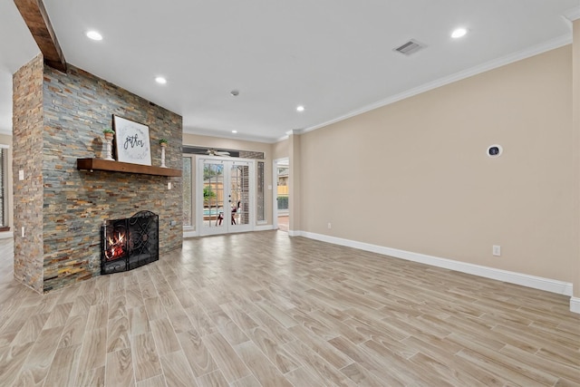 unfurnished living room with visible vents, baseboards, light wood-style flooring, french doors, and a fireplace