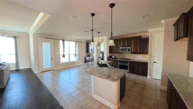 kitchen with backsplash, a wealth of natural light, stainless steel appliances, and a sink