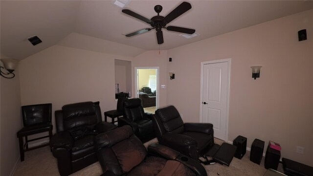 home theater room with vaulted ceiling, carpet floors, ceiling fan, and baseboards