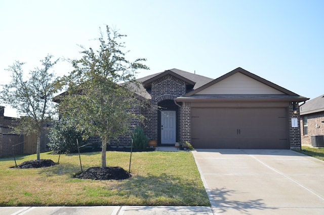 view of front of home featuring a garage, a front yard, brick siding, and driveway