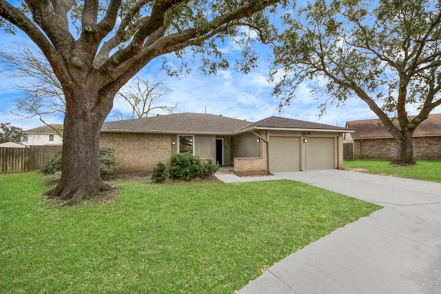 ranch-style house featuring fence, concrete driveway, a front yard, an attached garage, and brick siding