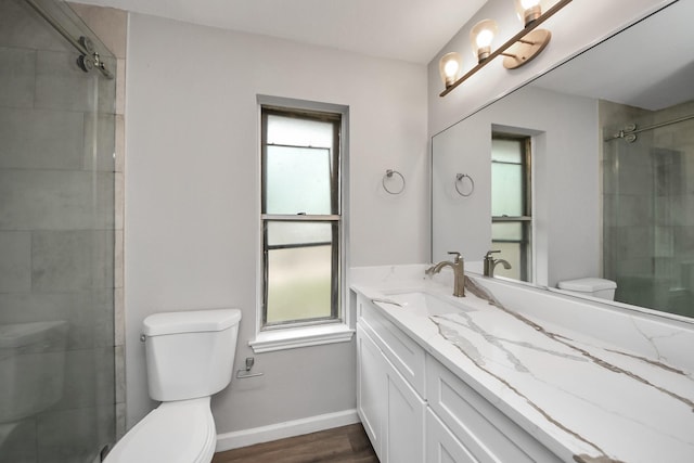 full bathroom with toilet, plenty of natural light, and tiled shower