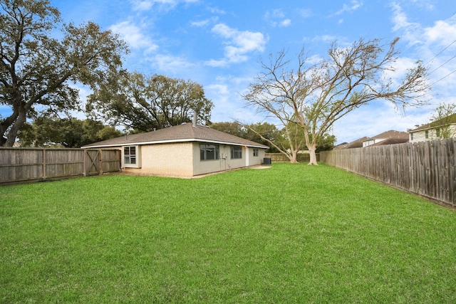 view of yard with a fenced backyard