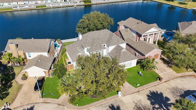 drone / aerial view featuring a water view and a residential view