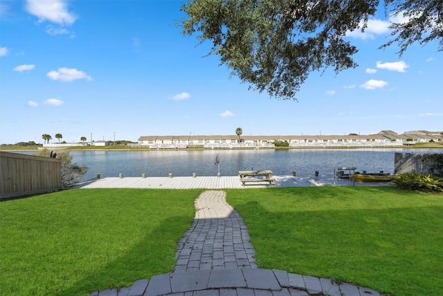 view of yard featuring a dock and a water view