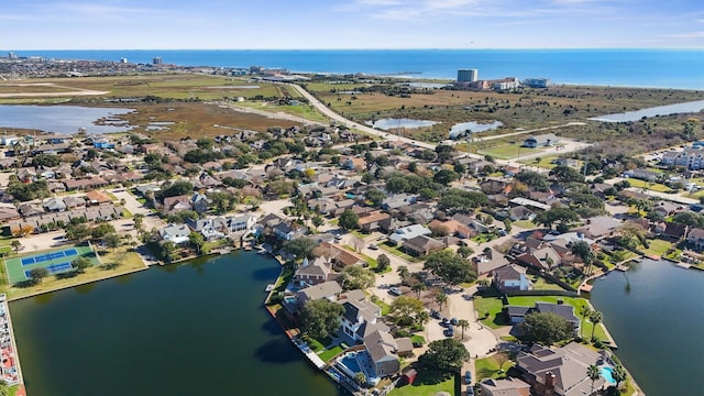 birds eye view of property with a water view and a residential view