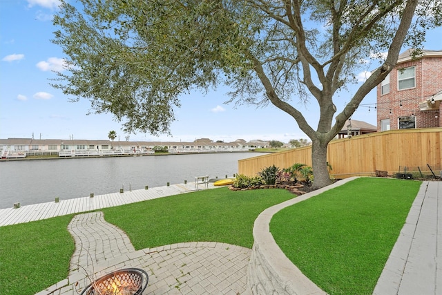 view of yard featuring a water view and fence