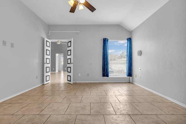 unfurnished room with vaulted ceiling, ceiling fan, baseboards, and tile patterned floors