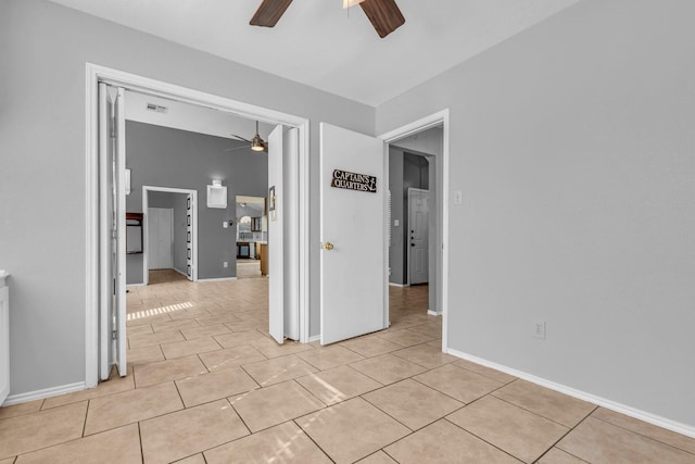 unfurnished room featuring light tile patterned floors, visible vents, and a ceiling fan