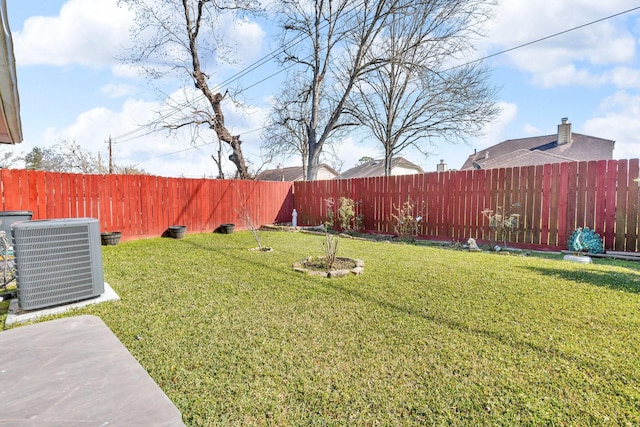 view of yard with a fenced backyard and central air condition unit