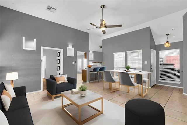 living area featuring a healthy amount of sunlight, visible vents, and light tile patterned floors