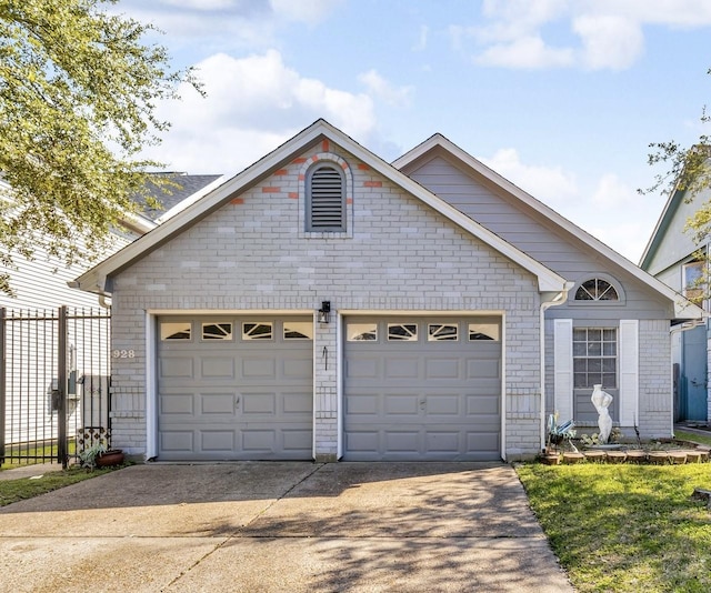 view of front of home featuring a garage, concrete driveway, brick siding, and fence