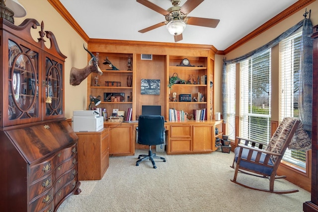 office area with light carpet, visible vents, ceiling fan, ornamental molding, and built in shelves