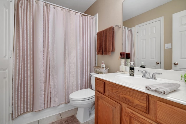 bathroom with vanity, toilet, and tile patterned floors