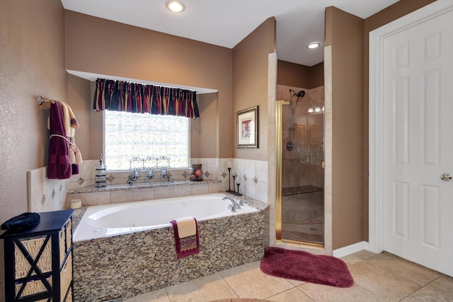 full bathroom with a stall shower, a bath, and tile patterned floors