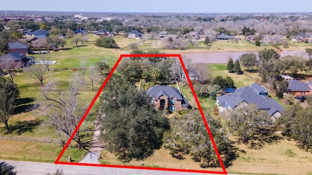 drone / aerial view featuring a water view and a residential view